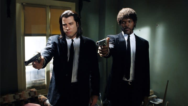 John Travolta and Samuel L. Jackson Jackson as Vincent Vega and Jules Winnfield aiming guns in the same direction in the film Pulp Fiction.