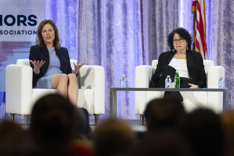 FILE - Supreme Court Justices Amy Coney Barrett, left, and Sonia Sotomayor speak with retired U.S. Appeals Court Judge Thomas Griffith, not shown, during a panel discussion at the winter meeting of the National Governors Association, Feb. 23, 2024 in Washington. In joint appearances less than three weeks apart, ideologically opposite Justices Amy Coney Barrett and Sonia Sotomayor said a Supreme Court where voices don’t get raised in anger can be a model for the rest of the country in these polarized times. (AP Photo/Mark Schiefelbein, File)