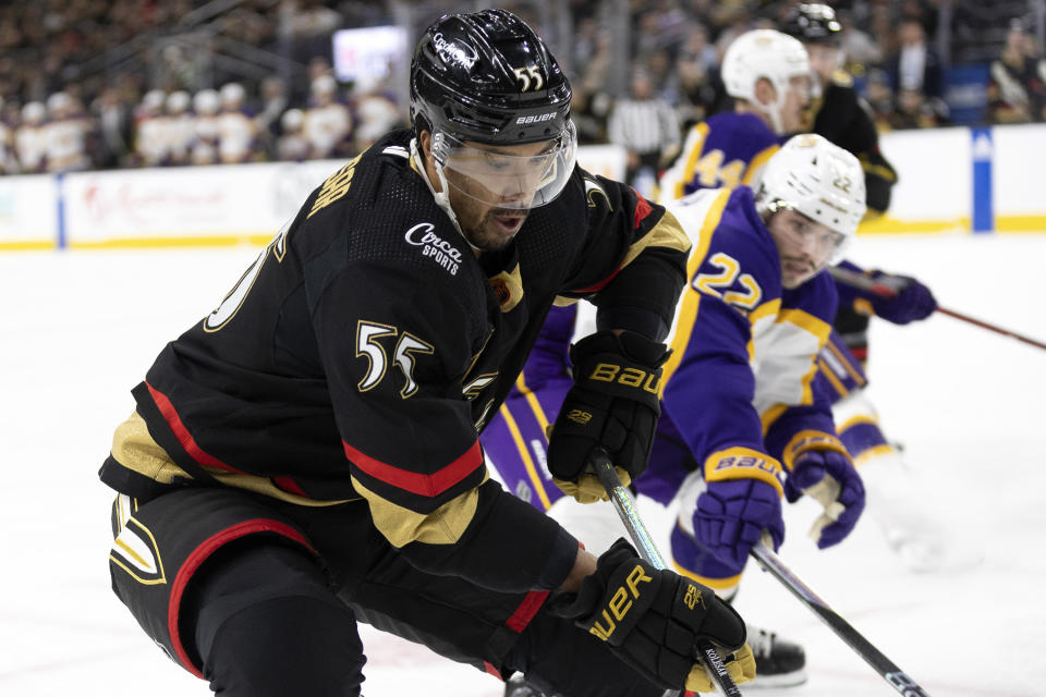 Vegas Golden Knights right wing Keegan Kolesar (55) skates for the puck against Los Angeles Kings left wing Kevin Fiala (22) during the second period of an NHL hockey game Saturday, Jan. 7, 2023, in Las Vegas. (AP Photo/Ellen Schmidt)