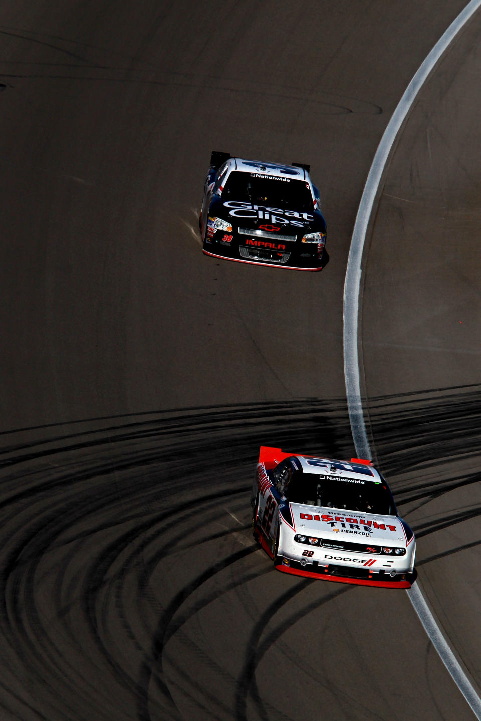 LAS VEGAS, NV - MARCH 10: Brad Keselowski, driver of the #22 Discount Tire Dodge, leads Kasey Kahne, driver of the #38 Great Clips Chevrolet, during the NASCAR Nationwide Series Sam's Town 300 at Las Vegas Motor Speedway on March 10, 2012 in Las Vegas, Nevada. (Photo by Ronald Martinez/Getty Images for NASCAR)