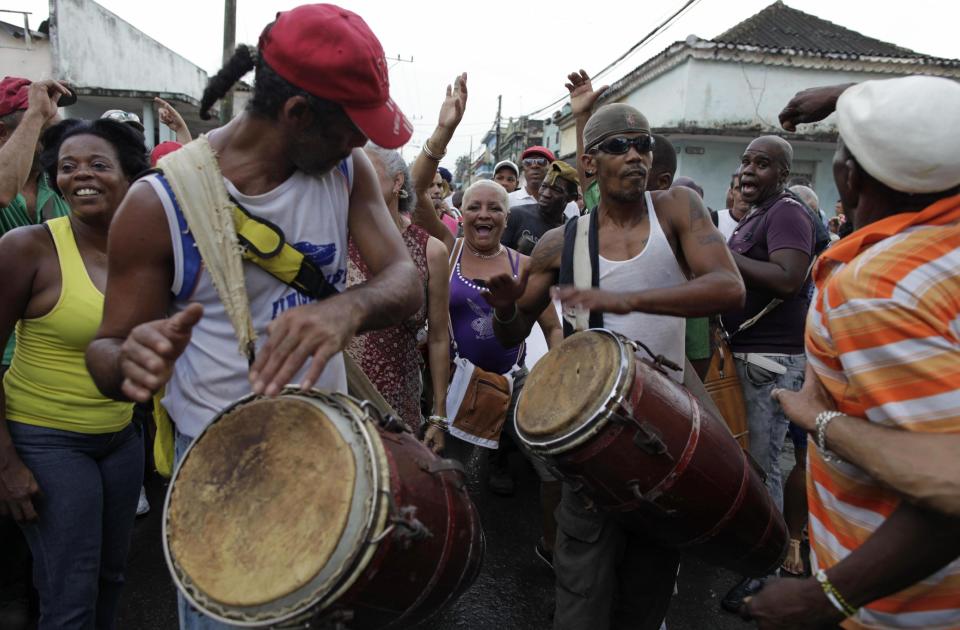 In this Feb. 5, 2014 photo, people play drums during the Burial of Pachencho celebration in Santiago de Las Vegas, Cuba. The tradition was born on Feb. 5, 1984, when villagers got the idea of putting on a mock burial to mark the end of local carnival season. It took its name from the title of a play that had showed in what was then the town theater. "Pachencho" is not representative of any real person, living or dead, explained Alvaro Hernandez, head of a learning and recreation center that today is housed in the former theater, "He's a product of popular imagination." (AP Photo/Franklin Reyes)