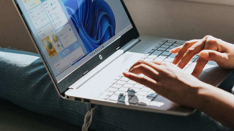 person typing on a laptop