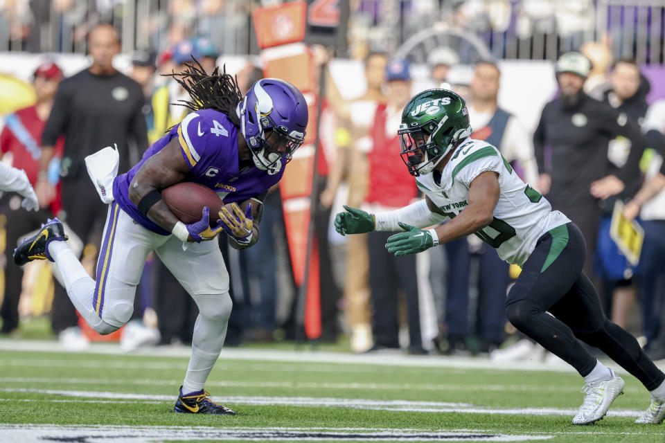 FILE - Minnesota Vikings running back Dalvin Cook (4) carries the ball against New York Jets cornerback Michael Carter II (30) during the second half of an NFL football game Sunday, Dec. 4, 2022 in Minneapolis. Free agent running back Dalvin Cook is scheduled to visit with the New York Jets this weekend, according to a person with knowledge of the situation.The former Minnesota Vikings star, who turns 28 in August, could join a revamped Jets offense led by quarterback Aaron Rodgers and coordinator Nathaniel Hackett.(AP Photo/Stacy Bengs, File)