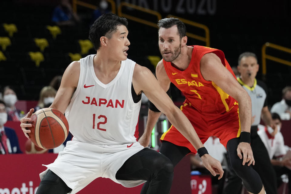 Japan's Yuta Watanabe (12) drives on Spain's Rudy Fernandez (5) during a men's basketball preliminary round game at the 2020 Summer Olympics in Saitama, Japan, Monday, July 26, 2021. (AP Photo/Eric Gay)