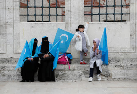 Uighur women hold East Turkestan flags at the courtyard of Fatih Mosque, a common meeting place for pro-Islamist demonstrators, during a protest against China, in Istanbul, Turkey, November 6, 2018. REUTERS/Murad Sezer