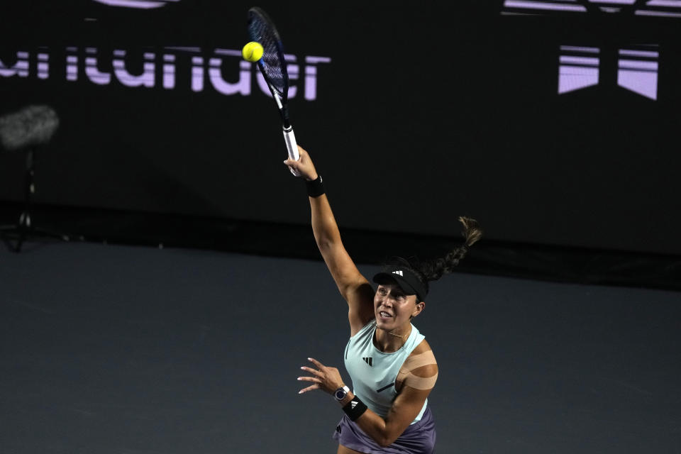 Jessica Pegula, of the United States, serves to Coco Gauff of the United States, during a women's singles semifinal match at the WTA Finals tennis championships, in Cancun , Mexico, Saturday, Nov. 4, 2023. (AP Photo/Fernando Llano)