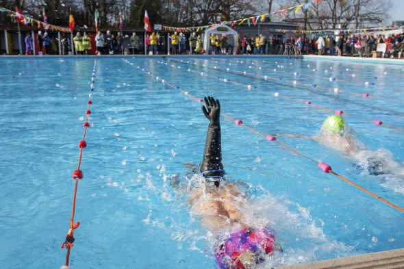 People take part in the 6th edition of the swimming race UK