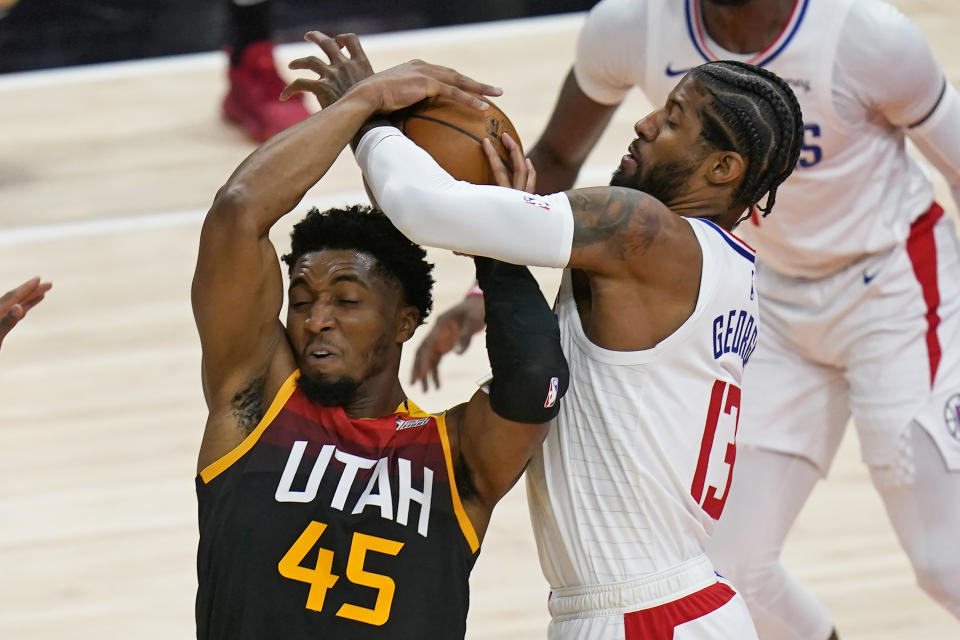 Utah Jazz guard Donovan Mitchell (45) and Los Angeles Clippers guard Paul George (13) vie for the ball during the first half of Game 2 of a second-round NBA basketball playoff series Thursday, June 10, 2021, in Salt Lake City. (AP Photo/Rick Bowmer)