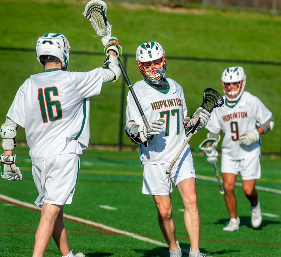 Hopkinton High School lacrosse player Logan Delponte, #77, congratulated by Chase O'Donnell, left, against Medway, April 29, 2024.