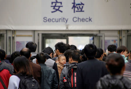 Tourists wait to enter Tiananmen Square through a security check point on the first day of a plenary session of the 18th Central Committee of the Communist Party of China (CPC), in Beijing, China, October 24, 2016. REUTERS/Jason Lee