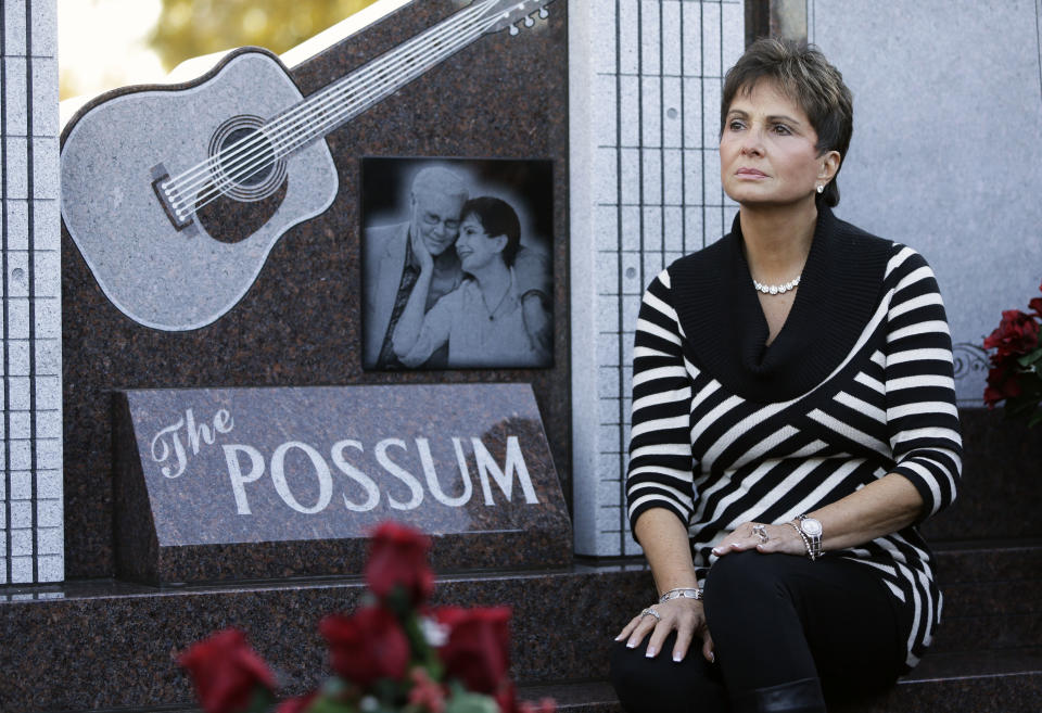 Nancy Jones, widow of country music star George Jones, listens as the Jones Boys band plays as she sits at the memorial unveiled at the late singer's grave on Monday, Nov. 18, 2013, in Nashville, Tenn. Nancy Jones spoke at the monument's dedication and announced a scholarship in her late husband's name at Middle Tennessee State University. George Jones died April 26. (AP Photo/Mark Humphrey)