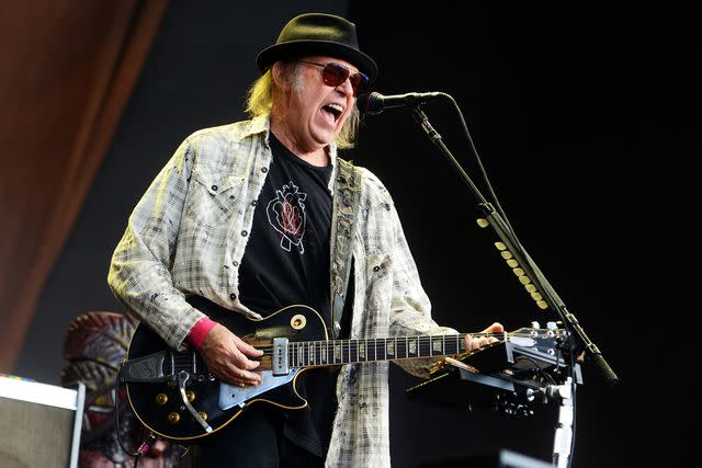 <p>Matthew Baker/Getty</p> Neil Young performing at Hyde Park in London on July 12, 2019