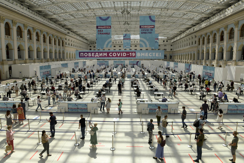 People wait in line for a COVID-19 vaccine at a vaccination center in Gostinny Dvora huge exhibition place in Moscow, Russia, Tuesday, July 6, 2021. Russia on Sunday reported about 23,387 new cases of coronavirus infection, the largest numbers since January, as the country faces a sharp surge over the past month. (AP Photo/Denis Kaminev)