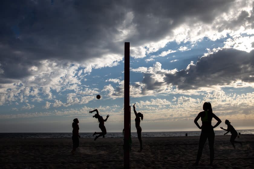 Hermosa Beach, CA - June 22: A group of self-described moms and dog-moms, gathered for their weekly volleyball game in Hermosa Beach, CA, Wednesday, June 22, 2022. After an previous evening and early Wednesday morning of various weather in Los Angeles, the sun was out and scattered clouds made for a great beach day, ending with some volleyball.(Jay L. Clendenin / Los Angeles Times)