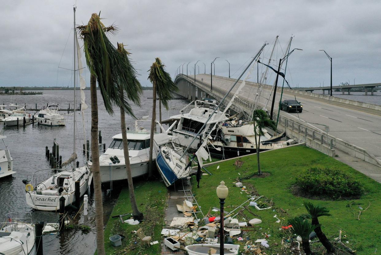 Boats are pushed up on a causeway after Hurricane Ian passed through the area on Sept. 29, 2022, in Fort Myers, Florida. The hurricane brought high winds, storm surge and rain to the area, causing severe damage.