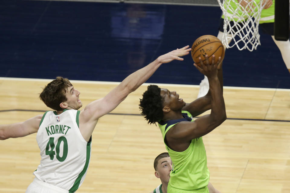 Minnesota Timberwolves forward Anthony Edwards (1) shoots in front of Boston Celtics center Luke Kornet (40) in the first quarter during an NBA basketball game, Saturday, May 15, 2021, in Minneapolis. (AP Photo/Andy Clayton-King)