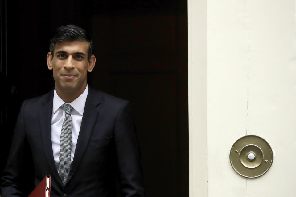 British Chancellor of the Exchequer Rishi Sunak leaves number 11 Downing Street, to deliver a financial announcement to the Houses of Parliament in London, Wednesday, July 8, 2020. British Treasury chief Rishi Sunak on Wednesday is set to announce a 2-billion-pound ($2.5 billion) program to create jobs for young people as the government tries to revive an economy battered by the COVID-19 pandemic. (AP Photo/Matt Dunham)