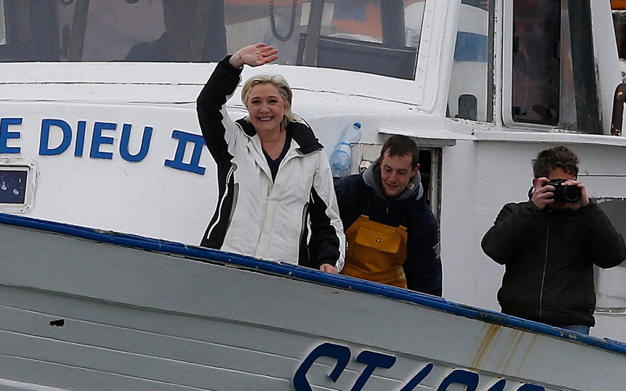 French presidential candidate Marine Le Pen waves upon her arrival on a fishing boat at the port of Grau du Roi, Southern France - EPA