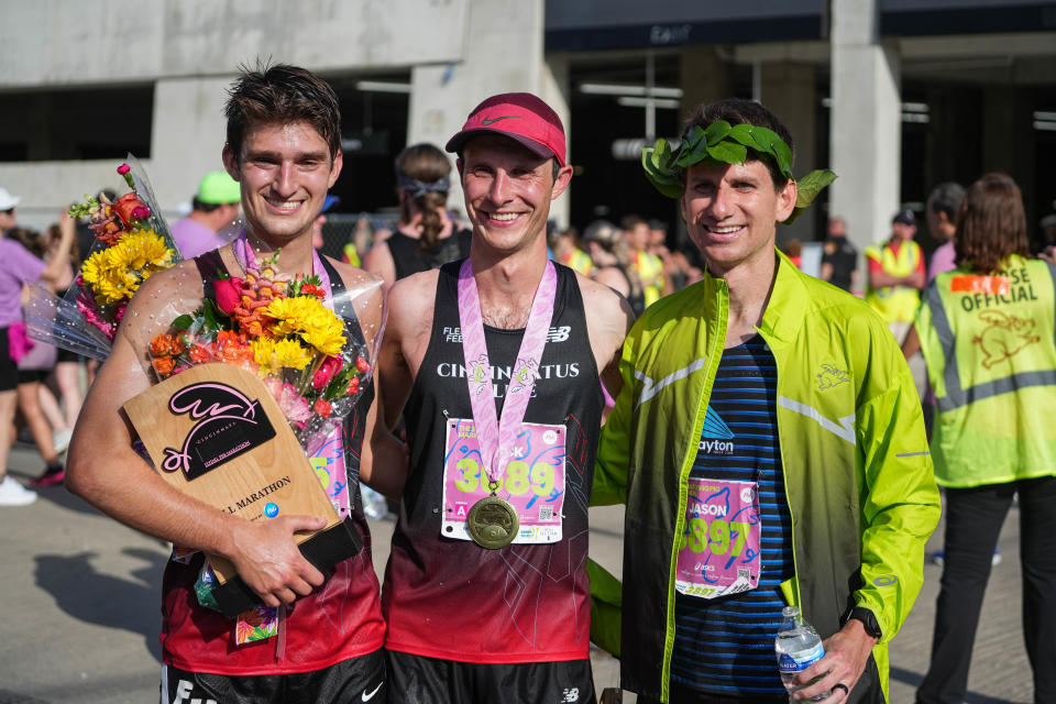 From left, Adam Beucler took second, Jack Randall took third and Jason Salyer took first in the men's 2024 Flying Pig Marathon on Sunday May 5, 2024.
