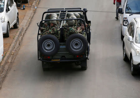 FILE PHOTO: Kenyan policemen ride in a truck as they leave the scene where explosions and gunshots were heard at the Dusit hotel compound in Nairobi, Kenya, January 16, 2019. REUTERS/Thomas Mukoya/File Photo