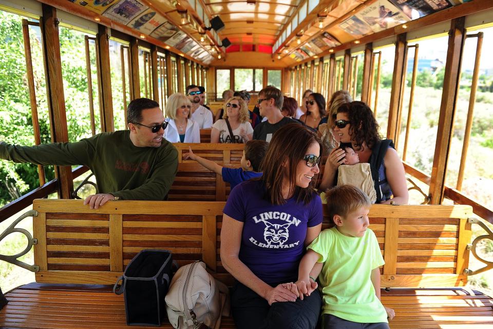 Liam Hanophy, 5, holds his mother, Amy Hanophy's, hand as they ride the Platte Valley Trolley in Denver, Colorado.