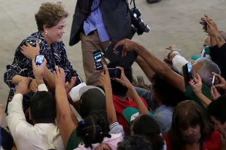 Brazil's President Dilma Rousseff is greeted by members of social movements after a signing ceremony for new housing units of the Minha Casa Minha Vida with rural and urban entities, at the Planalto Palace in Brasilia, Brazil May 6, 2016. REUTERS/Ueslei Marcelino