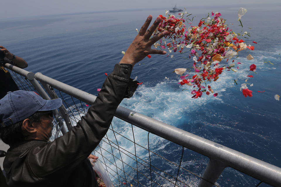 In this Tuesday, Nov. 6, 2018, file photo, a relative sprinkles flowers for the victims of the crashed Lion Air flight 610 from an Indonesia Navy ship in the waters where the airplane is believed to have crashed in Tanjung Karawang, Indonesia. (AP Photo/Tatan Syuflana, File)