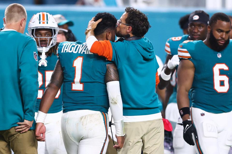 MIAMI GARDENS, FLORIDA - SEPTEMBER 12: Head coach Mike McDaniel of the Miami Dolphins embraces Tua Tagovailoa #1 after leaving the game with an injury during the third quarter against the Buffalo Bills at Hard Rock Stadium on September 12, 2024 in Miami Gardens, Florida. (Photo by Megan Briggs/Getty Images)