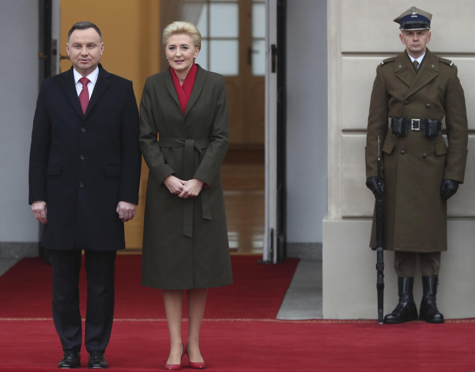 Poland's President Andrzej Duda,left, and first lady Agata Kornhauser-Duda wait to receive Danish Crown Prince Frederik and Princess Mary, before welcoming ceremony at the start of their one-day visit that marks 100 years of bilateral relations, in the Presidential Palace in Warsaw, Poland, Monday, Nov. 25, 2019. (AP Photo/Czarek Sokolowski)