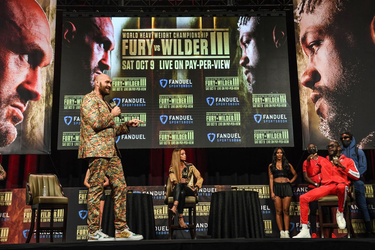 British boxer Tyson Fury (L) and challenger US boxer Deontay Wilder attend a press conference for their WBC heavyweight championship fight, October 6, 2021 at the MGM Grand Garden Arena in Las Vegas, Nevada ahead of their October 9, 2021 fight. (Photo by Robyn Beck / AFP) (Photo by ROBYN BECK/AFP via Getty Images)