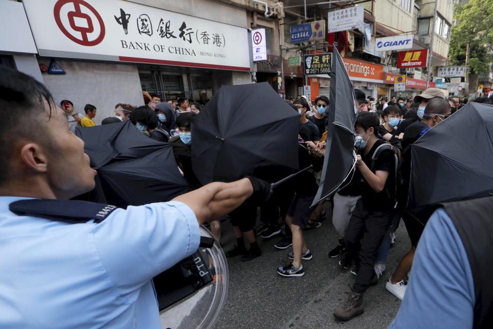 Police and protesters scuffle in Hong Kong on Saturday, July 13, 2019. Several thousand people marched in Hong Kong on Saturday against traders from mainland China in what is fast becoming a summer of unrest in the semi-autonomous Chinese territory. (AP Photo/Kin Cheung)