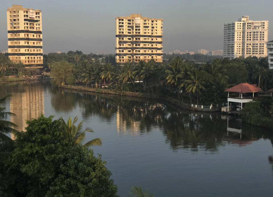 Water-front residential apartments Alpha Serene, left and center, and Holy Faith H2O, right, stand before they are scheduled to be razed to the ground by controlled implosion in Kochi, India, Saturday, Jan. 11. 2020. Authorities in southern Kerala state on Saturday razed down two high-rise luxury apartments using controlled implosion in one of the largest demolition drives in India involving residential complexes for violating environmental norms. (AP Photo/R S Iyer)