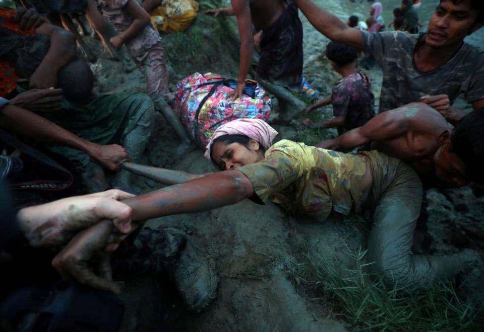 <div class="inline-image__caption"><p>Photographers help a Rohingya refugee to come out of Nad River as they cross the Myanmar-Bangladesh border in Palong Khali, near Cox's Bazar, Bangladesh, November 1, 2017. </p></div> <div class="inline-image__credit">Hannah McKay/Reuters</div>