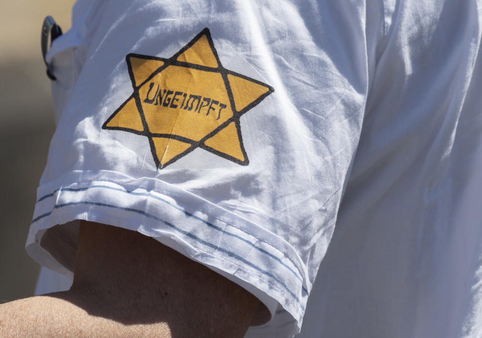 A man is seen wearing a yellow star of David with the the word "Unvaccinated" on his sleeve at a demonstration against coronavirus restrictions in Frankfurt, Germany on May 16, 2020. Some protesters in Germany, who've compared the current government's coronavirus restrictions to Nazi policies, have begun displaying such patches or arm bands, like the ones European Jews were forced to wear during the Holocaust. (Boris Roessler/picture alliance via Getty Images)