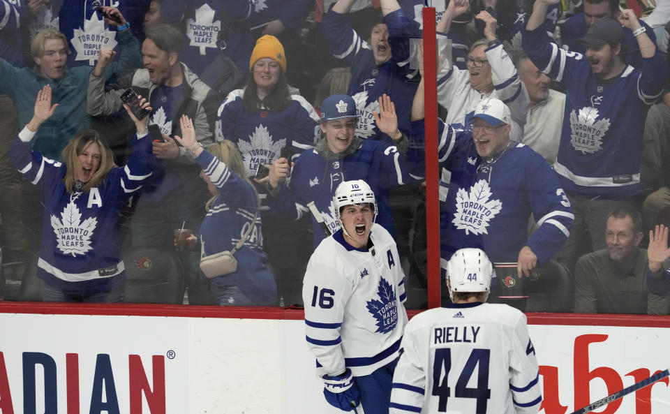 Fans react as Toronto Maple Leafs right wing Mitchell Marner celebrates his goal during the second period of an NHL hockey game against the Ottawa Senators, Saturday, March 18, 2023 in Ottawa, Ontario. (Adrian Wyld/The Canadian Press via AP)