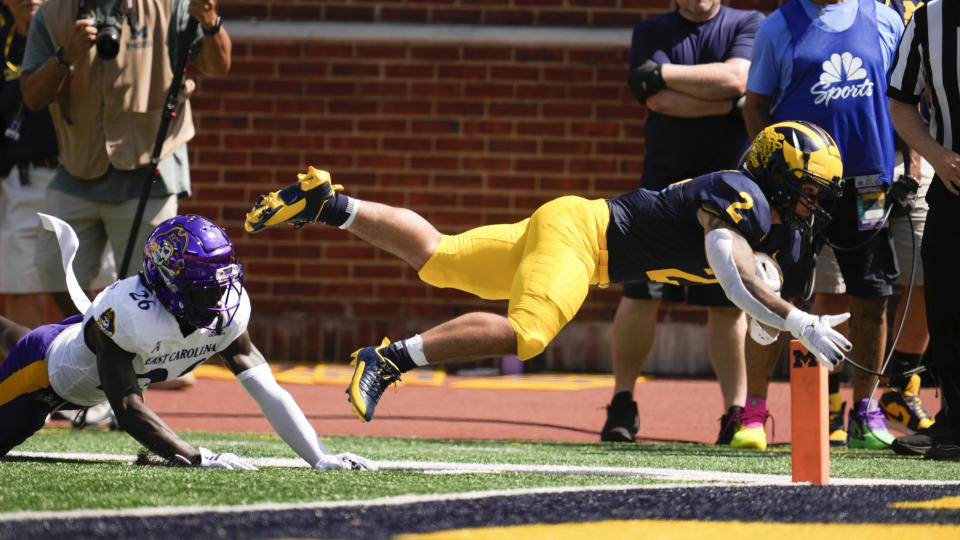 Michigan running back Blake Corum (2) dives for the end zone as East Carolina defensive back Isaiah Brown-Murray (26) defends in the first half of an NCAA college football game in Ann Arbor, Mich., Saturday, Sept. 2, 2023. Corum was short of the end zone. (AP Photo/Paul Sancya)