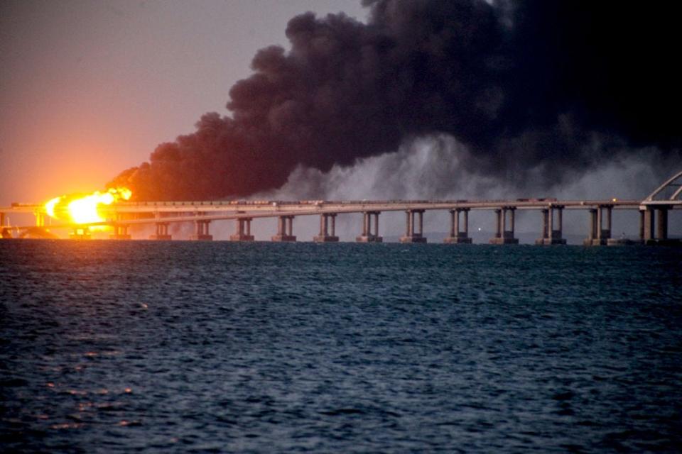 Explosion causes fire at the Kerch bridge in the Kerch Strait, Crimea on October 08, 2022. A fire broke out early Saturday morning on the Kerch Bridge -- preceded by an explosion -- causing suspension of traffic and bringing bus and train services to a halt.