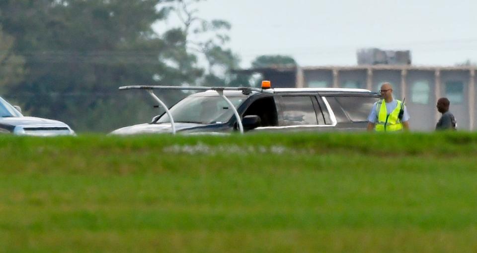 The landing gear of the crashed helicopter is visible from a distance Sunday at Space Center Regional Airport in Titusville.