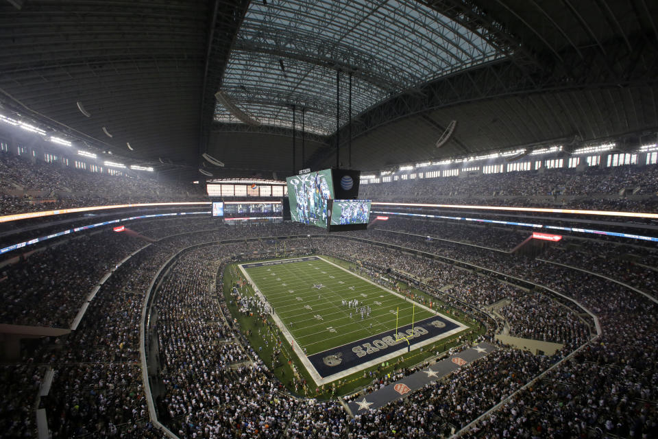 FILE - Fans watch at the start of an NFL football game inside AT&T Stadium between the New York Giants and Dallas Cowboys, Sunday, Sept. 8, 2013, in Arlington, Texas. There are 23 venues bidding to host soccer matches at the 2026 World Cup in the United States, Mexico and Canada. (AP Photo/Tony Gutierrez, File)