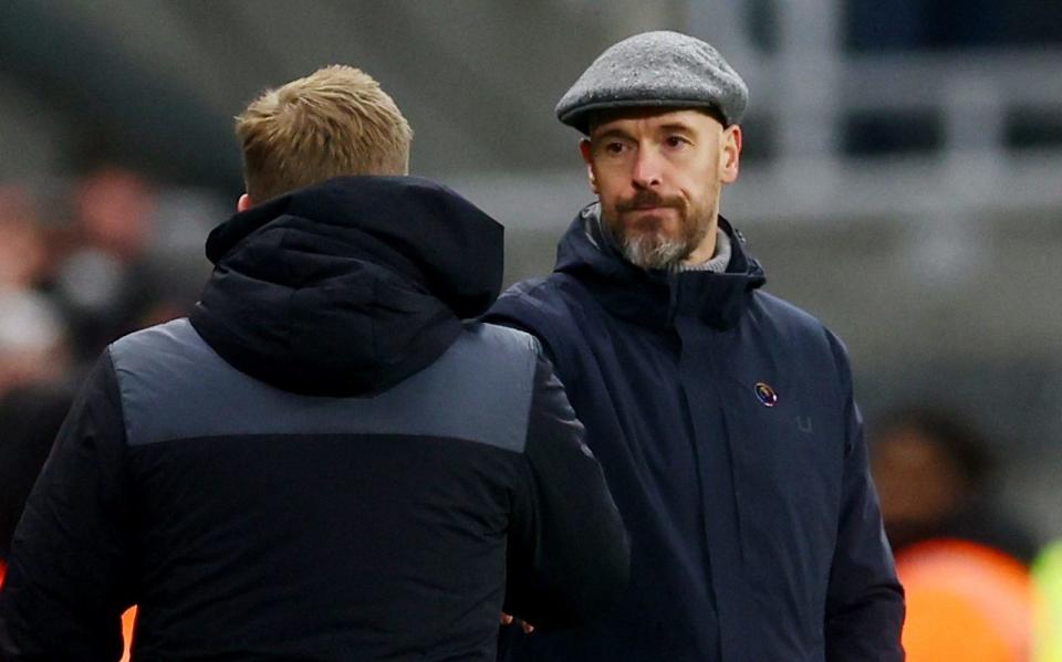 A dejected Erik ten Hag shakes hands with Eddie Howe at the end of the match