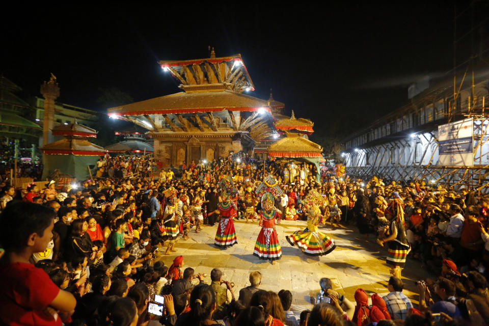 In this Sept, 28, 2018, photo, mask dancers perform during the last day of Indra Jatra festival in Kathmandu, Nepal. For centuries, Nepal has celebrated the Indra Jatra festival of masked dancers, which officially begins the month-long festivities in the Hindu-dominated Himalyan nation. The dancers, who come from a variety of backgrounds, pull off this performance every year despite minimal financial support from the government and other sources, they say. (AP Photo/Niranjan Shrestha)