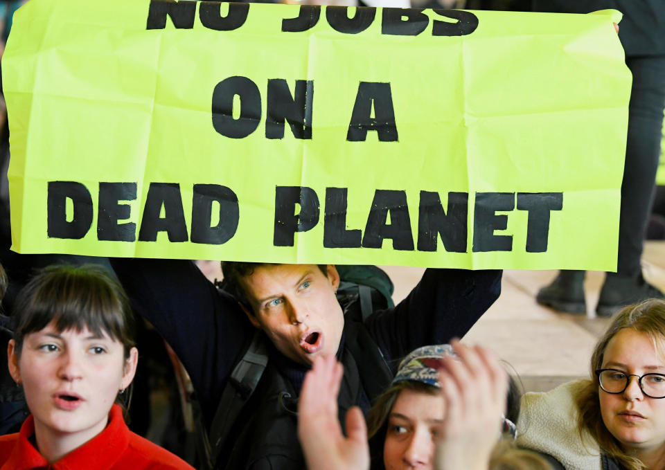 People demonstrate as Greenpeace stages a climate protest at Amsterdam Schiphol Airport in Schiphol, Netherlands December 14, 2019. REUTERS/Piroschka van de Wouw     TPX IMAGES OF THE DAY