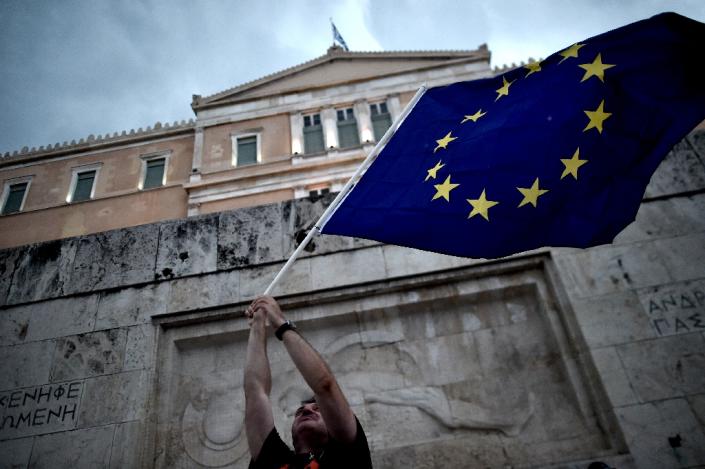 A pro-European Union protester waves an EU flag during a demonstration in front of the parliament in Athens on June 30, 2015 (AFP Photo/Aris Messinis)