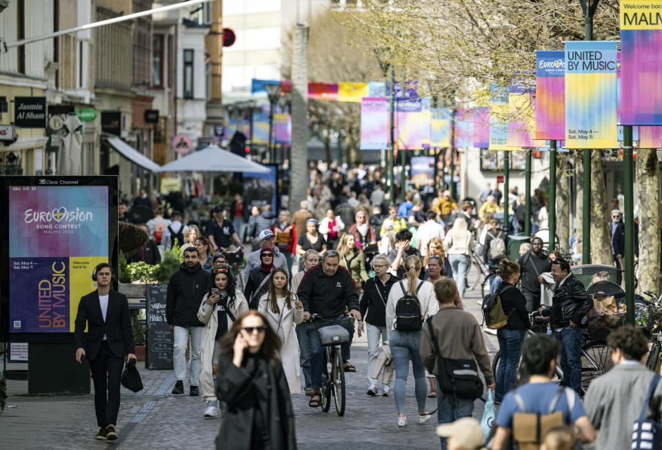 People walk along the Eurovision signposted pedestrian street Södra Förstadsgatan in central Malmö, Sweden, Tuesday, April 30, 2024. (Johan Nilsson/TT News Agency via AP)