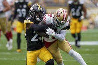 Pittsburgh Steelers safety Damontae Kazee, left, tackled San Francisco 49ers wide receiver Deebo Samuel during the first half of an NFL football game Sunday, Sept. 10, 2023, in Pittsburgh. (AP Photo/Matt Freed)