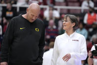 Stanford head coach Tara VanDerveer, right, talks with Oregon head coach Kelly Graves, left, before an NCAA college basketball game Friday, Jan. 19, 2024, in Stanford, Calif. (AP Photo/Tony Avelar)
