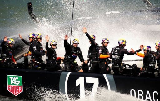 Oracle Team USA waves to spectators after winning race 16 of the America's Cup on September 23, 2013 in San Francisco