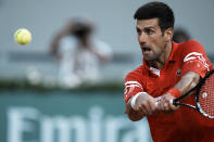 Serbia's Novak Djokovic returns the ball to Spain's Rafael Nadal during their semifinal match of the French Open tennis tournament at the Roland Garros stadium Friday, June 11, 2021 in Paris. (AP Photo/Thibault Camus)