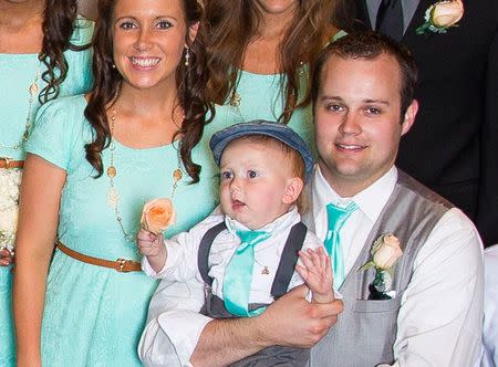 Anna Duggar, Marcus Duggar and Josh Duggar stand for a portrait on June 21, 2014 in Springdale, Arkansas. REUTERS/Discovery Communications/Handout