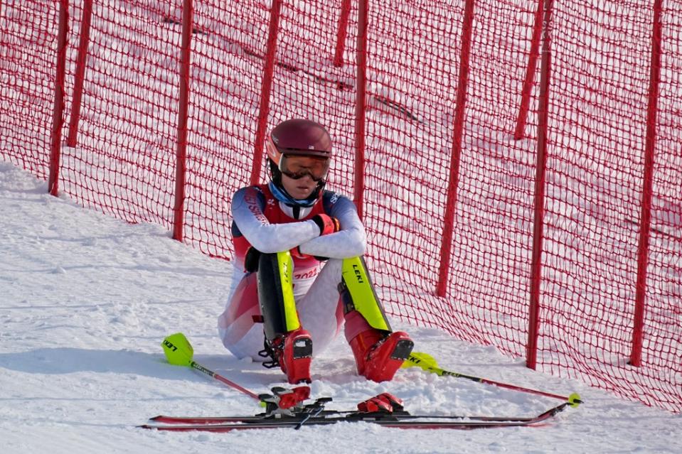 Mikaela Shiffrin, of the United States sits on the side of the course after skiing out in the first run of the women's slalom (AP)